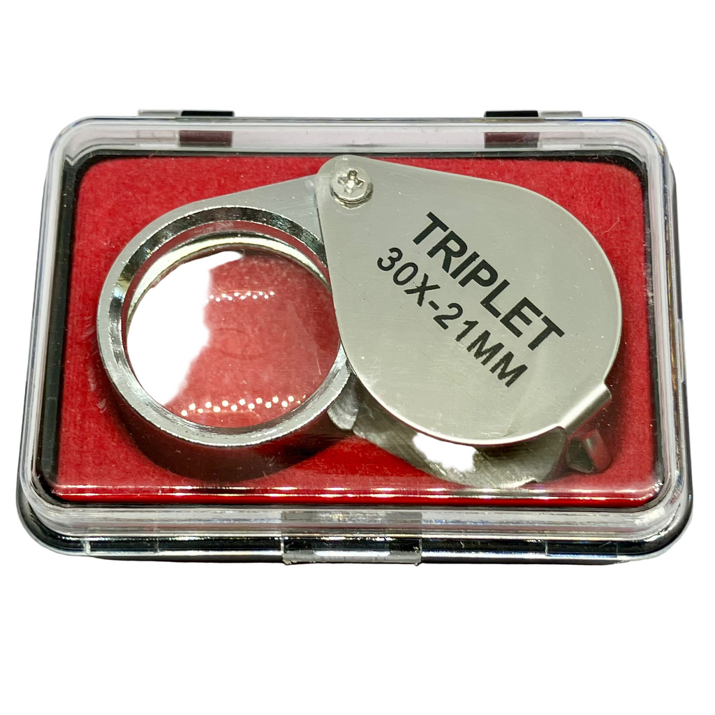 Silver triplet magnifier with red interior in clear case on white background